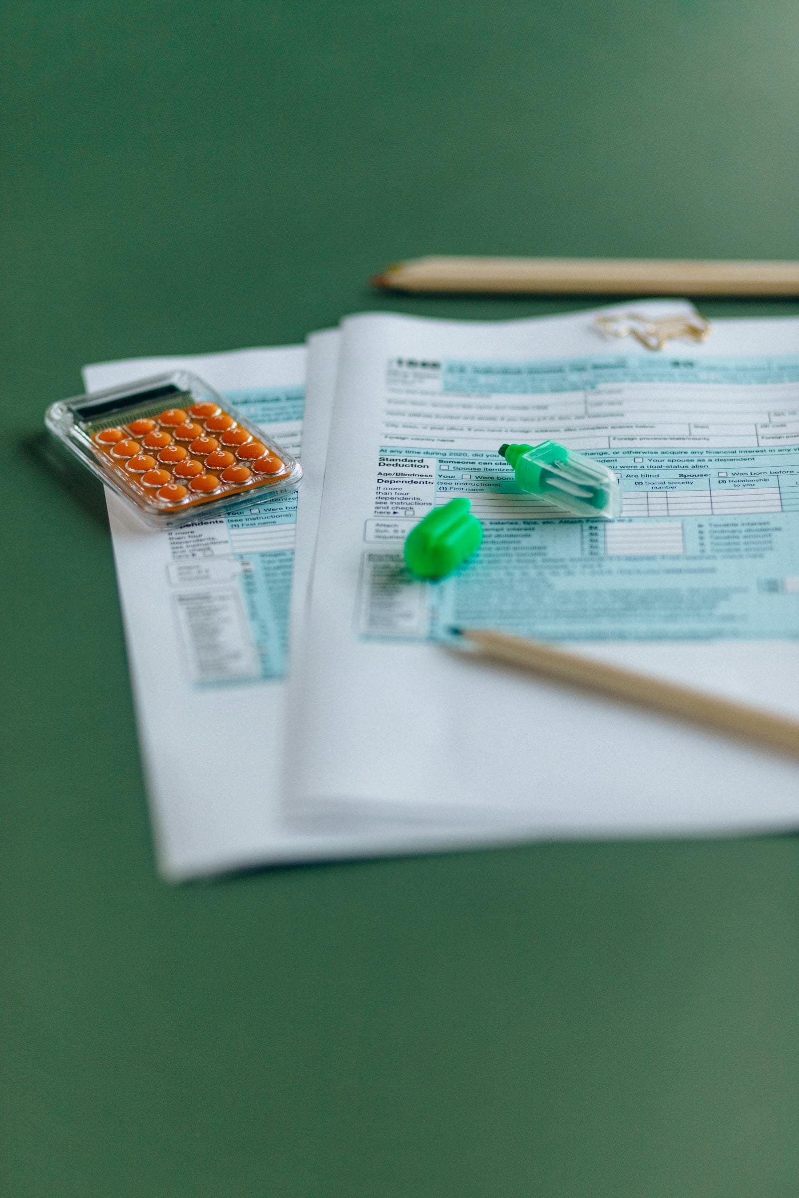 Tax documents and calculator on a desk